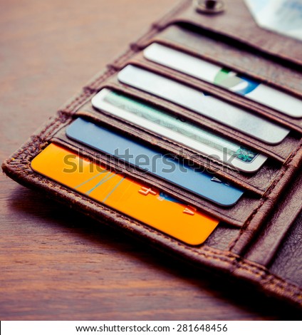 leather wallet with credit and discount cards. Artistic lighting and vintage processing