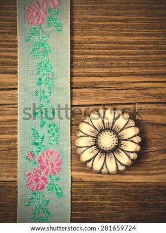 still life, vintage aqua color tape with embroidered ornaments and old button flower. instagram image filter retro style