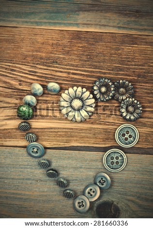 buttons heart on old textured boards of ancient tailor table. instagram image filter retro style