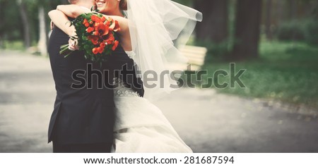 Summer picture of happy wedding couple outside.  Royalty-Free Stock Photo #281687594