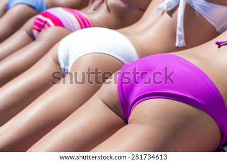 Girls in bikini sunbathing at the beach