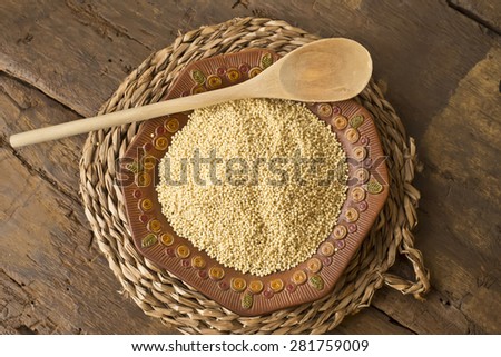 Peeled millet from organic farming on rustic wooden table