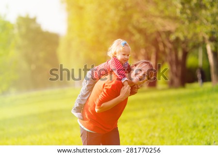 mother and little daughter having fun outdoors in summer
