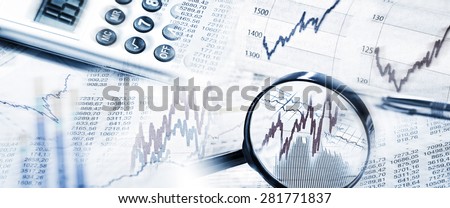 Stock Quotes as graphs and tables with magnifier and calculator in panoramic format Royalty-Free Stock Photo #281771837