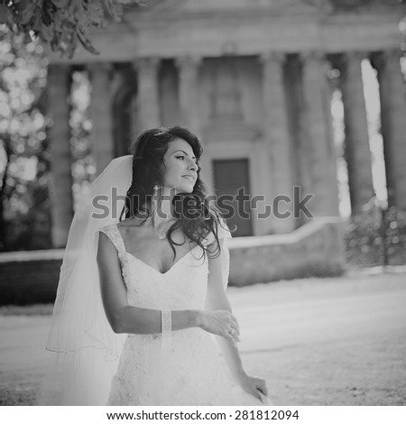 Wedding picture of happy brunette bride outside. 