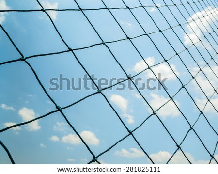Seamless mesh fence in football stadium on blue sky.