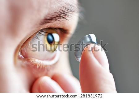 Medicine and vision - young woman with contact lens Royalty-Free Stock Photo #281831972