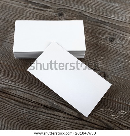 Photo of blank business cards on a wooden background. Template for branding identity. Top view.