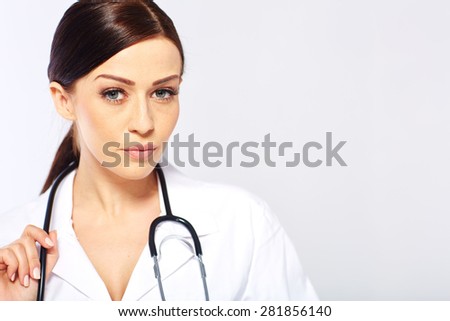 Medical doctor woman in a white studio