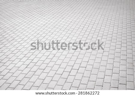 Gray brick stone street road. Light sidewalk, pavement or wall texture