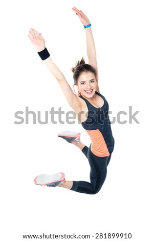 Happy sporty woman jumping isolated on a white background and looking at camera