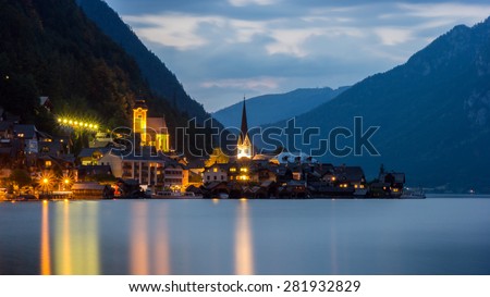 Hallstatt Scenic picture-postcard view of famous mountain village by Lake Hallstatt in the Austrian Alps under Golden Dramatic Sky at Night in Summer, Austria