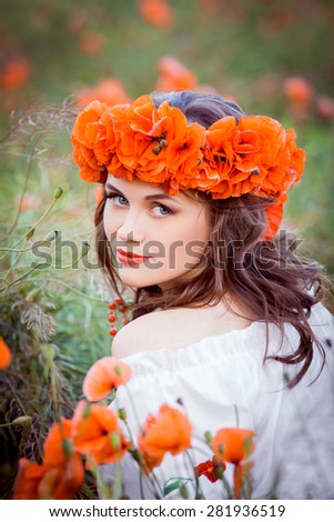 Beautiful girl  on the field with flowers.As the picture from an old book. Fashionable toning, picture in the style of fantasy.