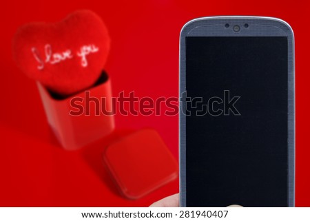 Blue smatrphone and I love you heart on red background. Idea for Valentines Day celebration, love, Father's or Mother's day, love apps, Internet, blogs and others.