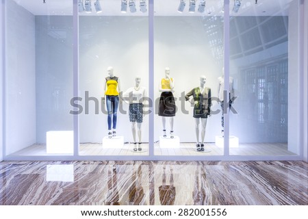 mannequins in fashion shop display window Royalty-Free Stock Photo #282001556
