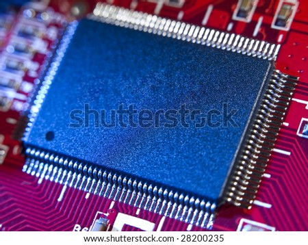 Close up on a memory chip in a red computer circuit board.