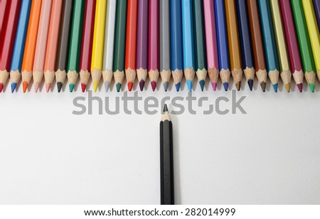 Isolated colored pencils with white background shows opposite between malignity and favor or shows discrimination