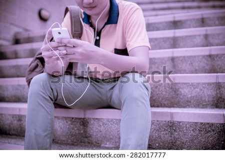 students sitting on stairs with their smartphones