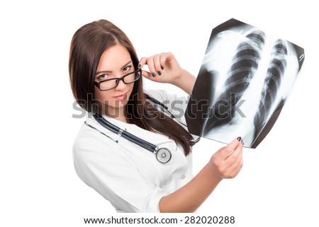 Young female doctor with a stethoscope looking at the x-ray picture of lungs on white 