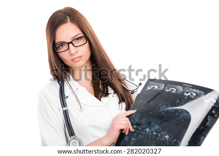 Young female doctor with a stethoscope looking at the x-ray picture of lungs and  brain MRI on white 