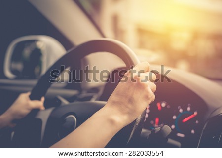 Female driving car. Vintage filter Royalty-Free Stock Photo #282033554