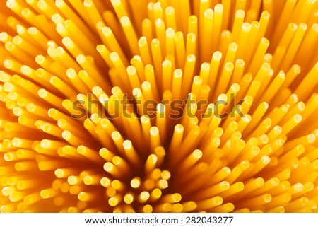 Raw spaghetti noodles background in vivid colors