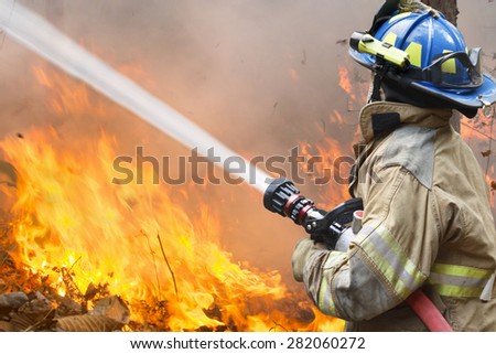 firefighters battle a wildfire Royalty-Free Stock Photo #282060272