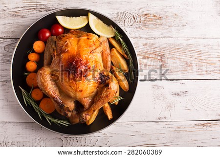 Roasted chicken and vegetables on the wooden table Royalty-Free Stock Photo #282060389