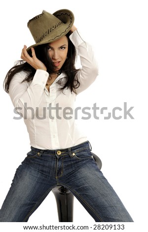Half body view of young fashion model posing with white blouse, blue jeans and cowboy hat. Isolated on white background.