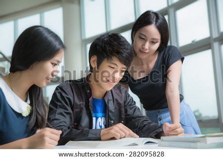 Asia students group read a book in Library Royalty-Free Stock Photo #282095828
