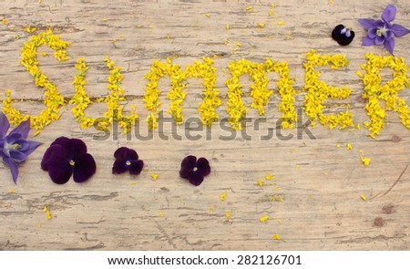 Inscription written with little buds of yellow wildflowers