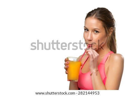 Young woman drinking an orange juice