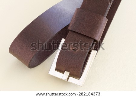 Brown belt with a buckle.