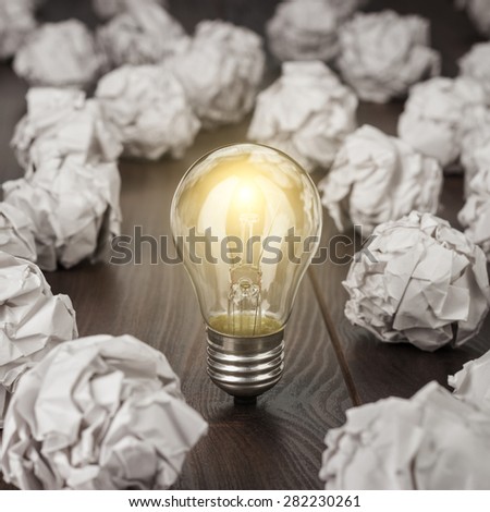 great concept with crumpled office paper and light bulb standing on the table Royalty-Free Stock Photo #282230261