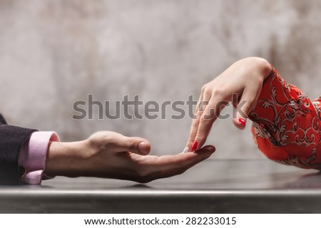 A couple hand in hand at a table Royalty-Free Stock Photo #282233015