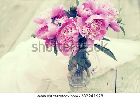 Pink roses in vase on wooden floor and bokeh background - retro styled photo