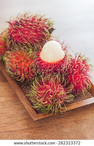 Fresh rambutans on wodden tray, stock photo