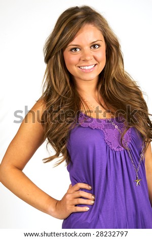 Portrait of a beautiful brunette teen wearing a purple shirt with a nice smile