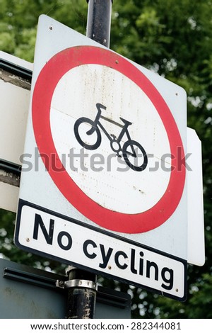no cycling information warning sign attached to a post