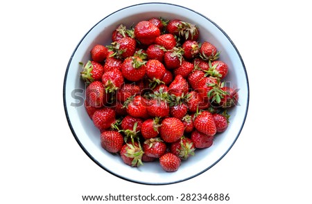 Red strawberries in a round bowl isolated on white