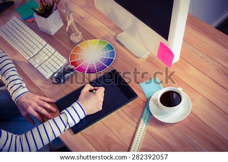 Designer using digitizer on desk in creative office
