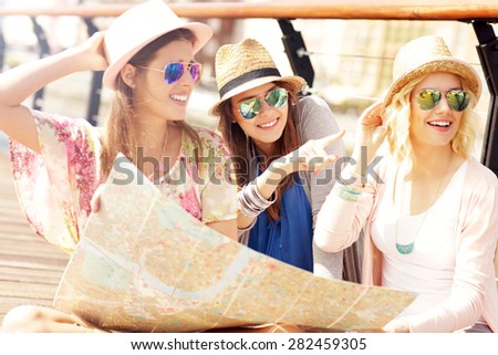 A picture of group of tourists using map in the city