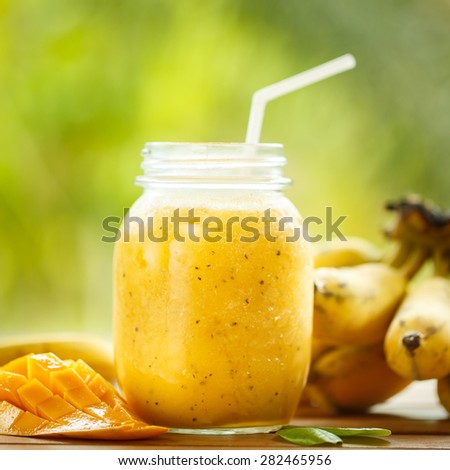 Smoothies mango and banana in a glass jar