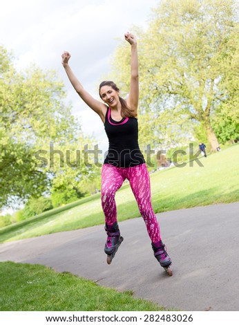 happy young woman with roller skates in the park