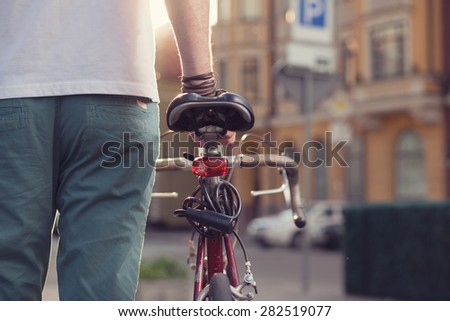 Closeup of stylish biker with vintage race bike