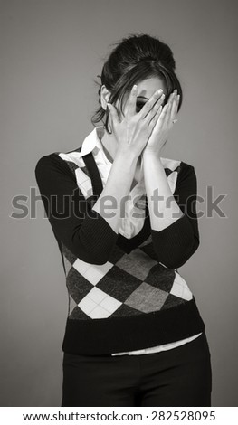 Adult indian woman in studio isolated on grey background, black and white image