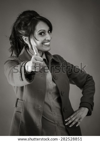 Adult indian woman in studio isolated on grey background, black and white image