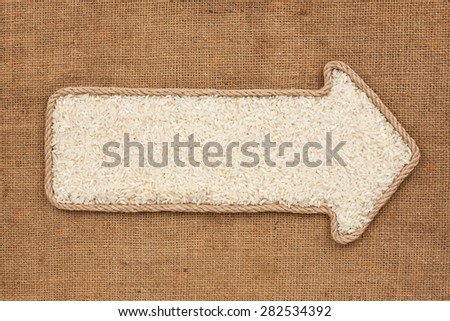 Pointer made from rope with grain rice  lying on sackcloth, with space for your text