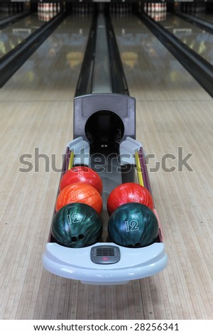 multicolor bowling balls and alley on background