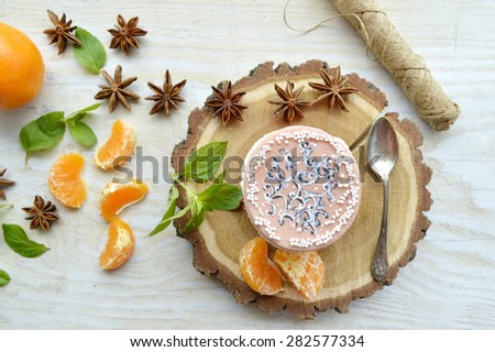 delicious, tender, tasty cupcakes with tangerine,decorated with mint leaves and star anise on a wooden tray